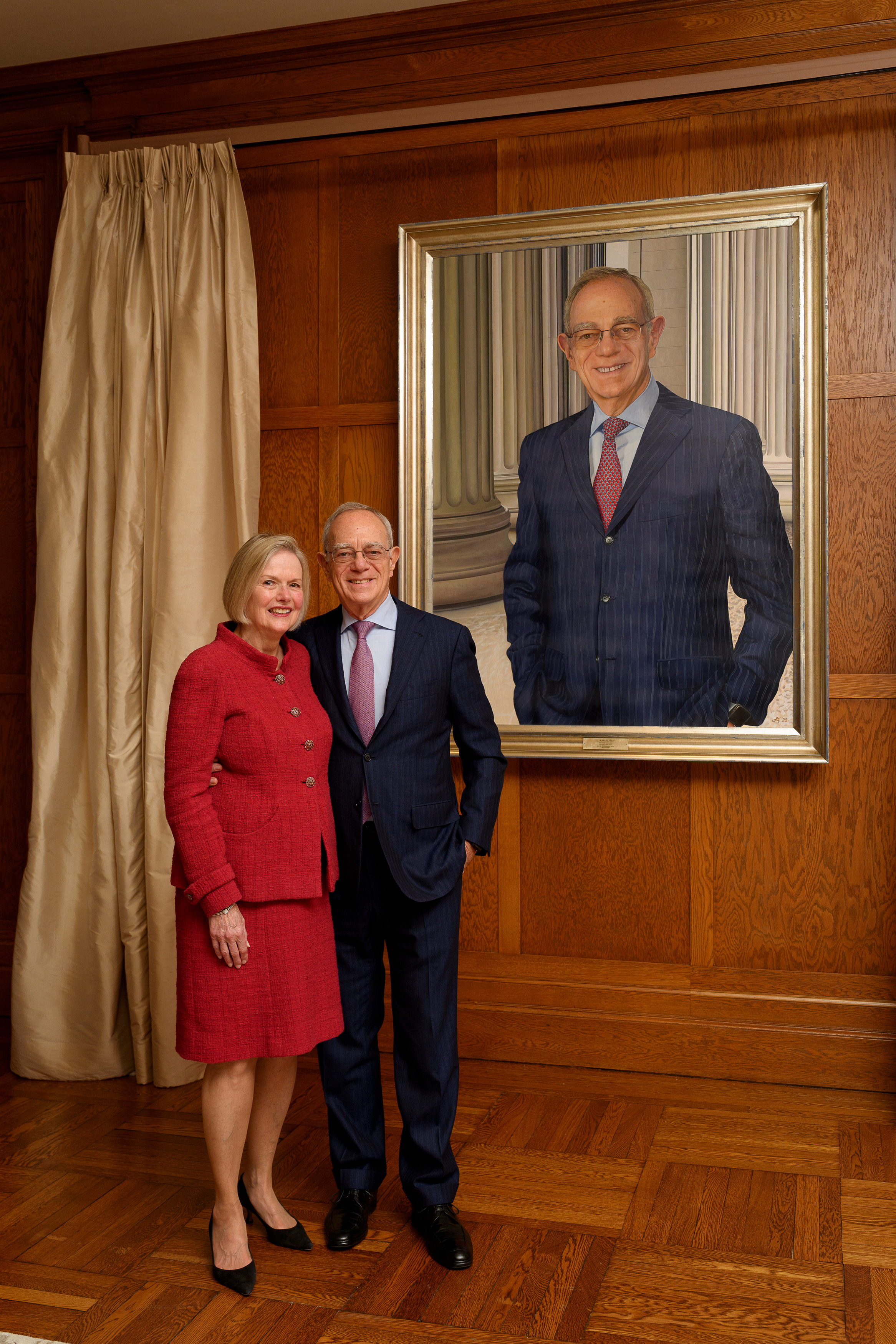 L. Rafael and Christine Reif stand next to the portrait.