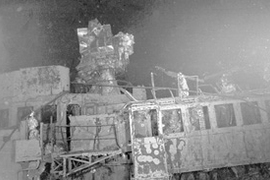 The USS Yorktown in her present state three miles deep on the bottom of the Pacific Ocean. This picture shows the ship's air traffic control center (the four windows on the right), topped by the remains of the gun director, an early version of computerized weaponry that included a telescope which directed the guns by remote control.