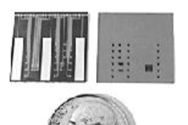 Front (left) and back views of a new microchip for the controlled release of chemicals. The dots between the three large bars (cathodes) on the front are the caps (anodes) covering the reservoirs that hold chemicals. An electrical voltage applied between a reservoir cap and a cathode causes a reaction that dissolves the cap, releasing the chemical. The back view shows the larger openings for each ...