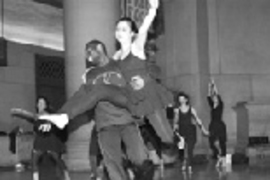 Olufemi Omojola, a graduate student in computer science, holds Nia Jetter, a senior in mathematics, as they complete a dance in Lobby 7 with their troupe Movements in Time during Campus Preview Weekend.