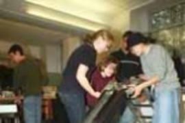 Students in 2.009 came up with some useful inventions, including Laddy, a ladder/dolly/motorized tool lift. Putting the finishing touches on Laddy are Heather Marshall (left), Elizabeth Ellingson (crouching) and Kathee Lee, all seniors in mechanical engineering.