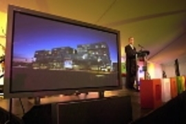 Simmons Hall glows on the screen on Vest's right at the dedication of the dorm in 2002.