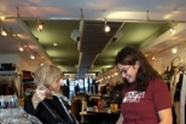 Betsy Jenney (left) shows Rayna Zacks some dresses at her Newbury Street boutique.