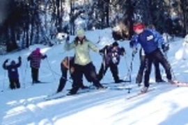 MIT students work on their herringbone technique as they cross-country ski up a hill.