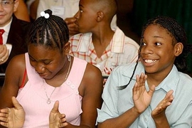 Kamisha Green, left, and Jennifer Jones clap in delight during the final program for STEM students at MIT.