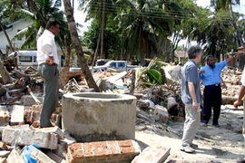 A coastal well surrounded by debris.