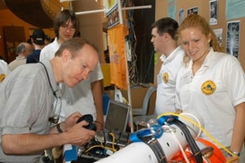 The team from Bow High School in New Hampshire, including Lauren Zeilinski at right, displays its Remotely Operated Vehicle for Education and Research (ROVER) at the InvenTeams Odyssey at MIT.