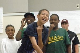 Middle school students in MIT's Science of Baseball summer program practice pitching in the classroom after learning the physics of a curve ball. Pictured from left are Brendan Gomez, Aaron Higginbottom, Alex Nickerson (who just released the ball), Samej Gauthier and program coordinator Jason Larocque.