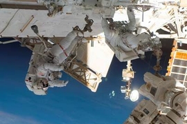 Endeavour astronauts Mike Foreman (left) and Rick Linnehan assemble the two-armed robotics system called a Special Purpose Dextrous Manipulator.