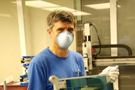 John Tonry of the Institute for Astronomy holds an entire array of 60 chips; an array of 60 OTAs will be installed in the focal plane of each of the four cameras in the Pan-STARRS facility.