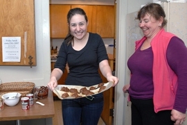 Freshman Betsy Flowers comes out of ESG kitchen with her "Death by Chocolate" chocolate chip cookies as instructor Patti Christie looks on.