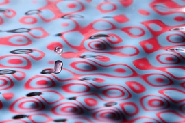 Close-ups of an experiment conducted by John Bush and his student Daniel Harris, in which a bouncing droplet of fluid was propelled across a fluid bath by waves it generated.