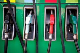 Closeup of four fuel handles at a gas station