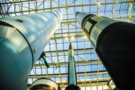 Three missiles point skyward under a glass ceiling.