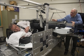 Swedish astronaut Christer Fuglesang tries out the new centrifuge while MIT professor Larry Young coaches him on. 