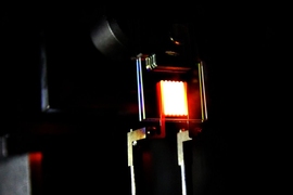 A proof-of-concept device built by MIT researchers demonstrates the principle of a two-stage process to make incandescent bulbs more efficient. This device already achieves efficiency comparable to some compact fluorescent and LED bulbs.
