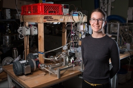 Emily Tow PhD '17, displays equipment she developed to measure the effects of different pressure levels on the way microorganisms build up on membranes used for desalinating water.
