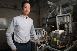 XiaoYu Wu pictured with the reactor his team used for the research. MIT researchers have developed a new system that could potentially be used for converting power plant emissions of carbon dioxide into useful fuels. The method may not only cut greenhouse emissions; it could also produce another potential revenue stream to help defray its costs.
