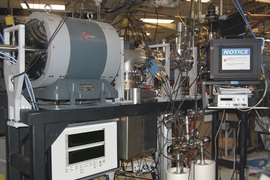 The ion beamline at Sandia National Labs where the new radiation damage measurement system has been installed and tested. The radiation damage process is observed in a target chamber located behind the black-box laser enclosure on the right of the image. 