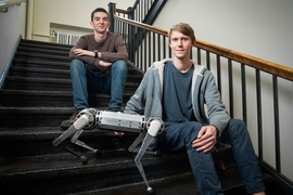 Benjamin Katz (right), a technical associate in mechanical engineering, and electrical engineering and computer science senior Jarod Di Carlo developed a robotic cheetah that can perform a backflip.
