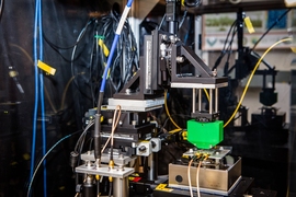 The experimental setup used by the researchers to test their sensor system. The sample being tested is on the stage just below the narrow end of the green box, right of center, which houses magnets.