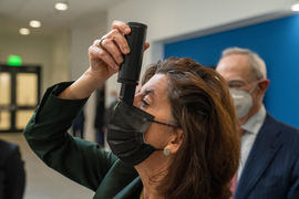 Gina Raimondo looks through a spectrometer