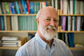 Richard Hynes in an office with bookshelves in background.