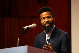 Joshua Bennett speaking at a podium