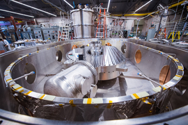 Close-up of large magnet inside a cylindrical cryostat container