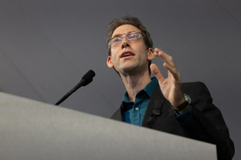 Aram Harrow speaking at a podium