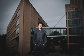 David Kastner stands at Ames street with Building 66 in background.