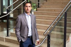 Andrew Sutherland stands near a stairway inside Sloan.