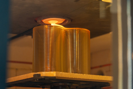 In the hot 3D printer, a tube of glass is extruded as the glass brick is made.