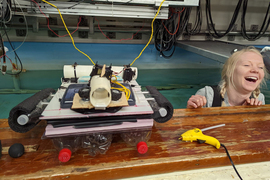 A device made of trash and plastic bottles is ready for the tank. Heather Willis smiles in the water.