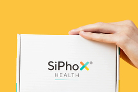 Hands hold a box that says SiPhox.