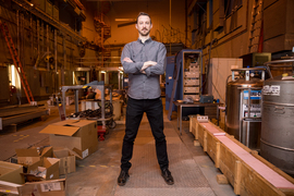 Zach Hartwig stands in the Plasma Fusion and Science Center building.