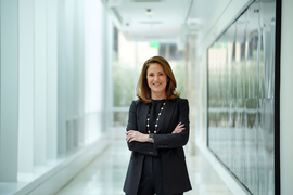 Cynthia Barnhart stands in hallway