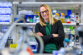 Stefanie Spranger portrait in the lab, with blurry equipment in foreground.